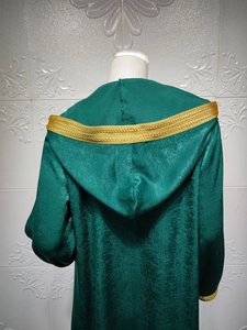 Detail of the hooded green velvet robe back with ornate gold lace trim and vertical pleats