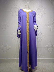 Detail of purple Abaya featuring gold embroidered trim and layered ruffle sleeves