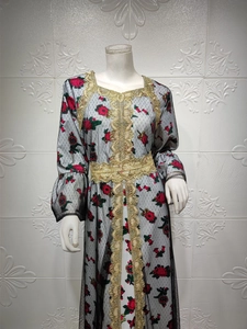 Detail of floral embroidery and gold lace trim on ethnic mesh kaftan maxi dress