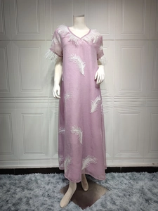Detailed close-up of lavender dress featuring white leaf embroidery and soft feather trim