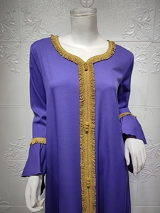 Detailed close-up of golden lace embroidery on the purple chiffon sleeve with ruffled cuffs