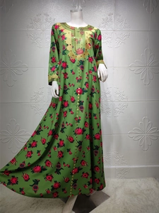 Detailed close-up of golden embroidery and sequins on this emerald floral maxi dress