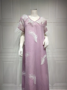 Detail of V-neckline with white feather trim and embroidery on purple maxi dress