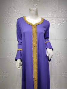 Detail showing the intricate gold embroidery and flared lotus sleeves on the purple abaya dress