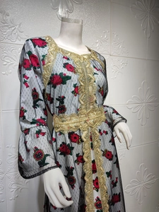 Detail of red rose floral embroidery and gold sequin lace trim on black mesh maxi dress