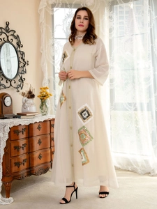 Close-up detail of geometric sequin embroidery on an elegant beige abaya dress