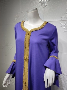 Detailed view of purple dress with lotus sleeves and intricate gold embroidered lace trim