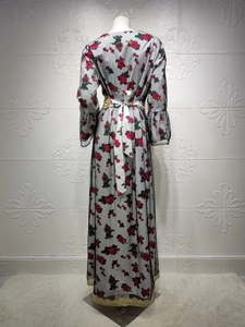 Detail of floral mesh dress back featuring red roses and golden embroidery trim lace