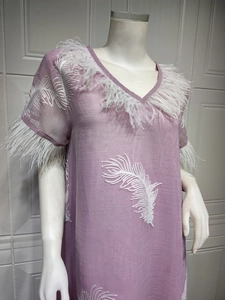 Detailed embroidery and white feather trim on the neckline of a purple dress