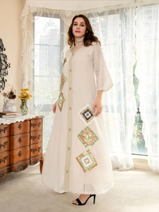 Close-up of golden embroidery and sequins on this elegant beige Kaftan dress detail