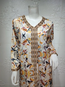 Détails de la broderie du col en V et de l'imprimé abstrait vif sur une robe Abaya longue