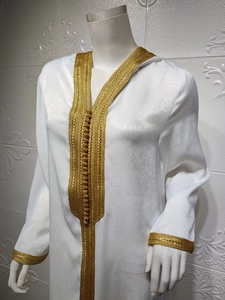 Detailed view of the champagne satin hooded kaftan with intricate gold embroidery and buttons