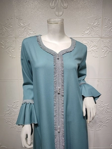 Close-up of grey-blue abaya dress featuring silver pleated trim and flared lotus sleeves