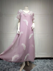 Detail of lilac maxi dress with white feather trim and airy chiffon fabric textures