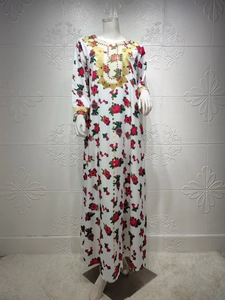 Detail of floral white Kaftan with golden sequin embroidery on neckline and sleeves