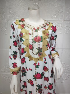Detail of floral print maxi dress with intricate gold embroidery and sequin embellishments