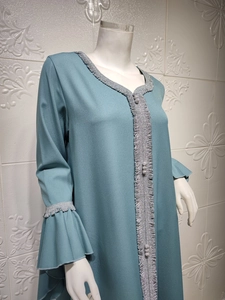 Detailed silver braided trim and ruffle sleeves on teal embroidered long dress