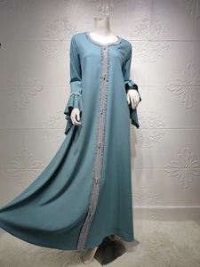 Close-up of gray-blue Abaya dress with silver lace trim and double-layered ruffle sleeves