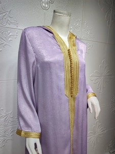 Detailed embroidery and gold trim on champagne purple velvet hooded kaftan dress