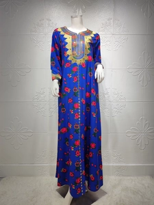 Detail of dark blue kaftan dress with rose floral patterns and gold embroidery