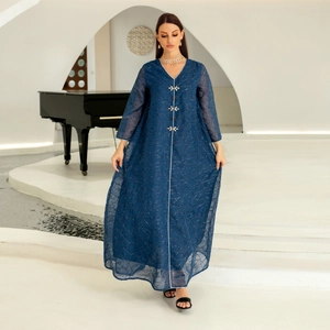 Detail of dark blue mesh embroidery abaya with floral buttons and beaded textures