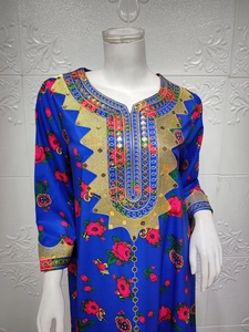 Close-up of royal blue ethnic dress with red rose print and ornate gold sequin embroidery