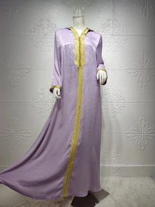 Detailed close-up of golden embroidery on the neckline of a lavender velvet kaftan dress