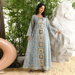 Detail of square sequin embroidery and gold thread trimming on blue kaftan dress