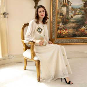 Robe longue blanche élégante avec broderie géométrique et manches longues style bohème
