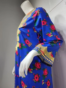 Close-up of royal blue satin dress with golden embroidery and floral prints for women