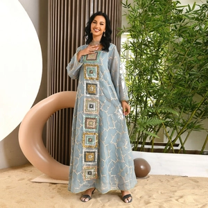 Detail of light blue sequin embroidery and gold thread textures on a long abaya dress