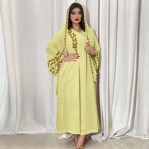 Detailed golden leaf embroidery on light green chiffon abaya sleeve and matching hijab