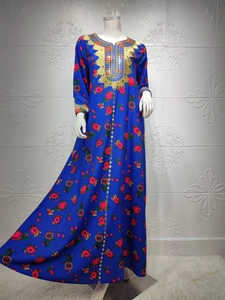 Close-up of royal blue floral maxi dress with intricate gold embroidery and sequins