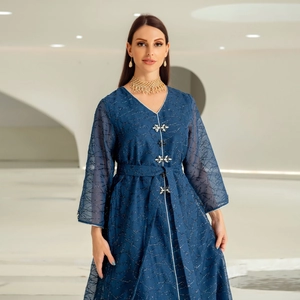 Detailed view of dark blue abaya dress with floral rhinestone buttons and glitter fabric