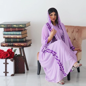 Detail of purple chiffon abaya showing intricate leaf vein embroidery and matching hijab