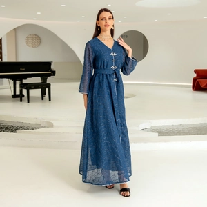 Detailed view of dark blue V-neck dress with silver wave embroidery and rhinestone buttons
