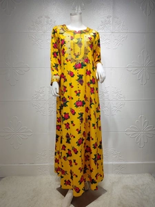 Detailed close-up of golden embroidery and sequins on the yellow floral Kaftan dress