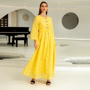 Elegant yellow embroidered kaftan dress featuring luxury gold patterns and rhinestone buttons