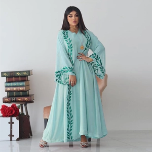 Close-up of intricate green leaf embroidery on a light blue chiffon dress sleeve