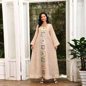 Detail of champagne gold kaftan dress featuring square sequin embroidery on front