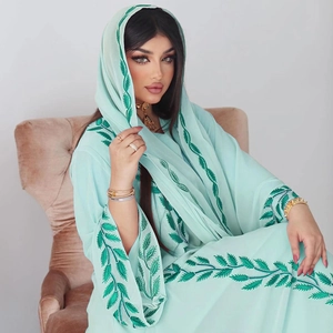 Detail of mint green Abaya with dark green leaf embroidery and matching headscarf