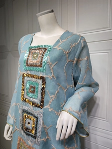 Detailed embroidery and sequins on light blue kaftan dress with golden branch patterns