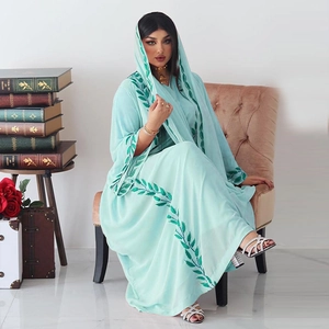 Detailed view of mint green chiffon dress with dark green leaf embroidery and matching hijab