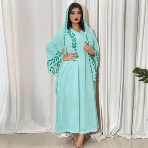 Detail of teal chiffon maxi dress featuring green leaf embroidery on cuffs and matching hijab