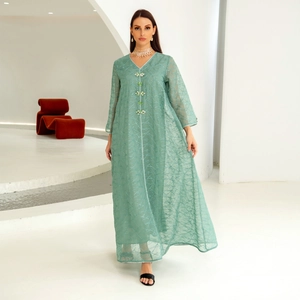 Close-up of green mesh embroidery dress with exquisite crystal beaded flower buttons