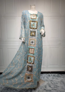 Detail of light blue sequined maxi dress featuring ethnic style embroidery and chiffon fabric