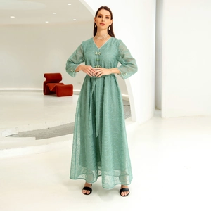 Mint green kaftan dress with geometric embroidery and floral button details