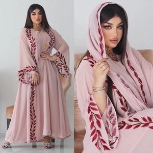 Close-up of pink chiffon abaya with deep red feather embroidery and matching hijab