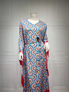 Detailed view of pink fringe tassels on long sleeve printed dress with geometric patterns