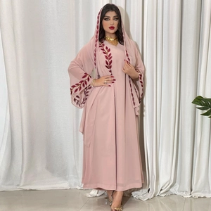 Close-up of intricate embroidery on pink chiffon abaya with matching floral patterns